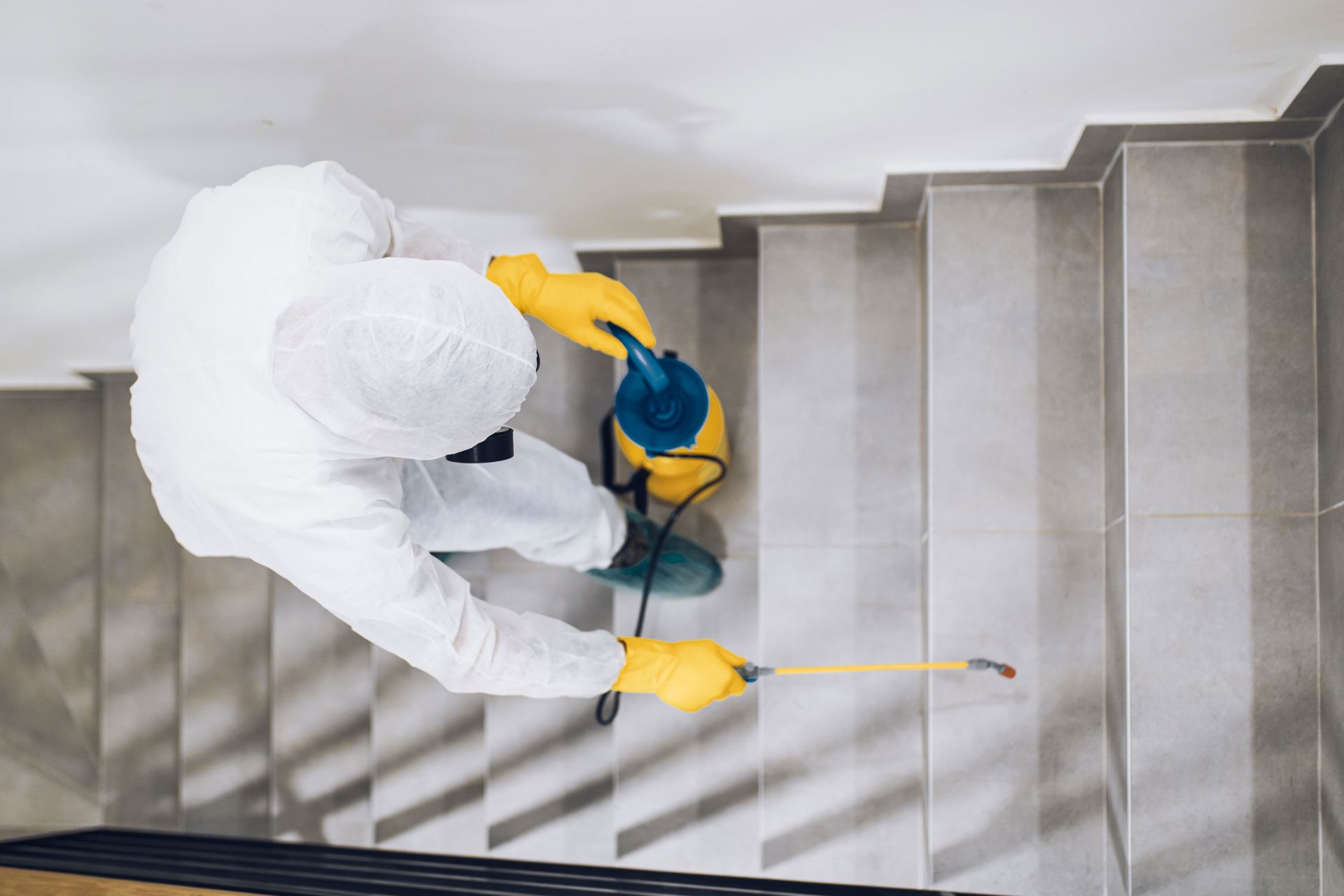 Technician spraying a staircase